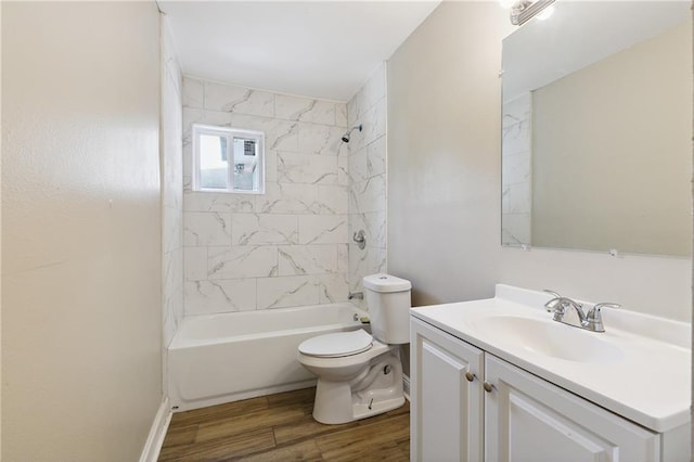 full bathroom with toilet, hardwood / wood-style floors, vanity, and tiled shower / bath