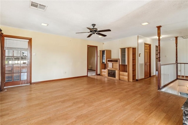 unfurnished living room featuring ceiling fan and light wood-type flooring