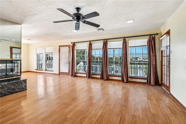 4210 Murano Rd, New Orleans, LA 70129 - unfurnished living room with wood finished floors, a ceiling fan, plenty of natural light, a textured ceiling, and a water view