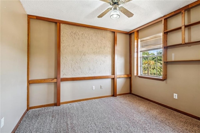 carpeted empty room with a textured ceiling and ceiling fan