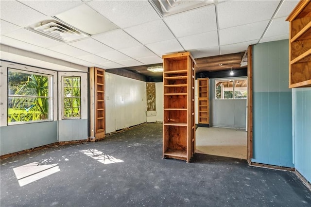 interior space with a paneled ceiling