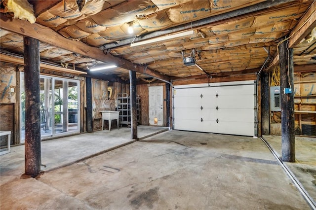 garage featuring electric panel and a garage door opener