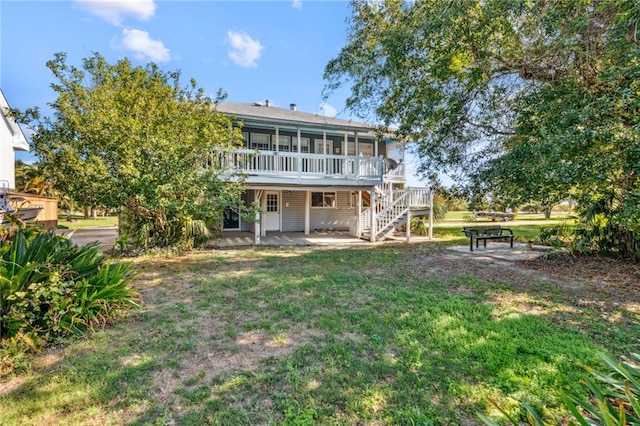 rear view of property with a sunroom and a yard