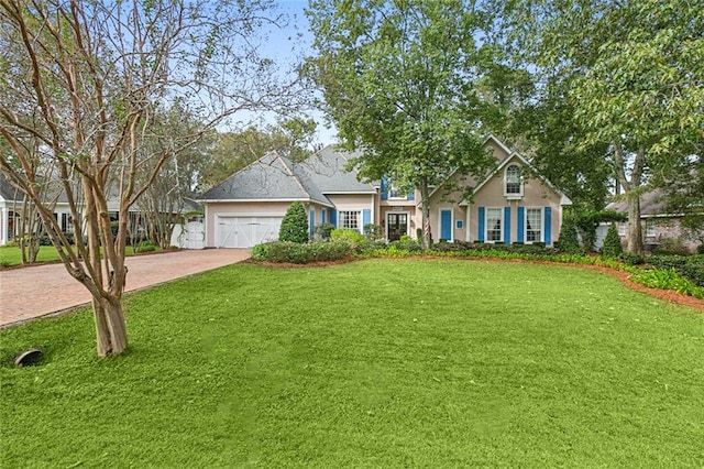 view of front of home with a garage and a front lawn