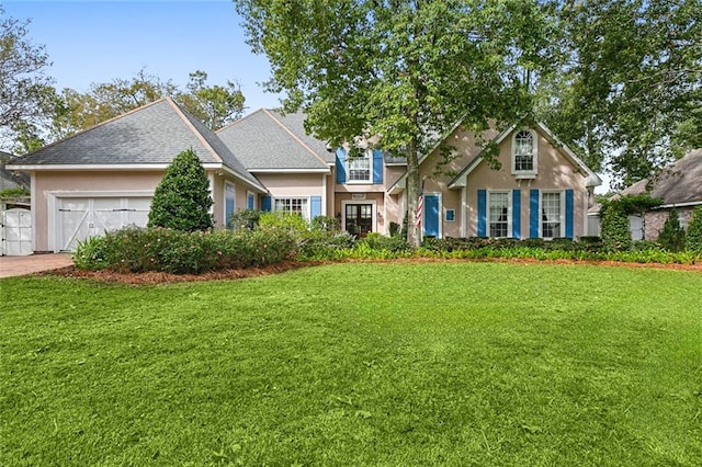 view of front of home featuring a garage and a front yard