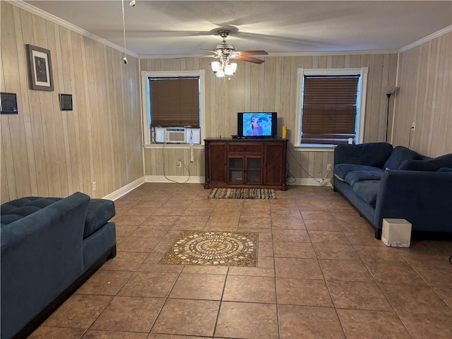 living room with ceiling fan, wood walls, crown molding, and cooling unit