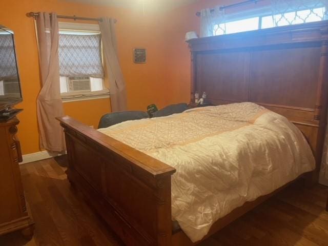 bedroom featuring cooling unit and dark wood-type flooring