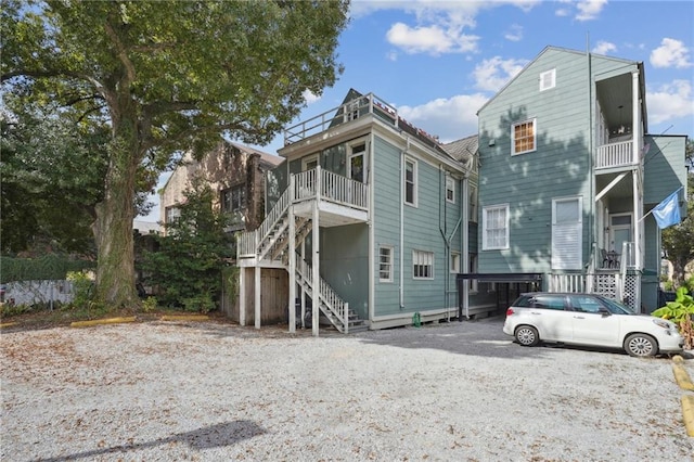 rear view of house featuring a balcony