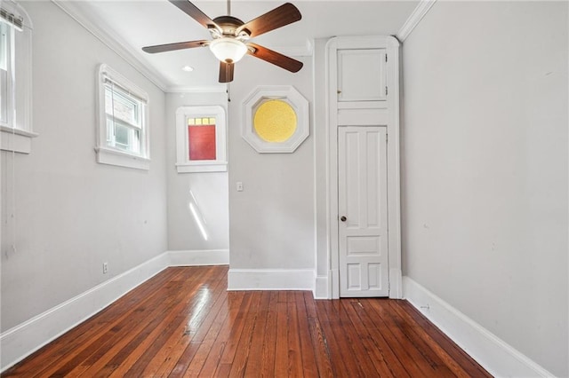 unfurnished room featuring ornamental molding, dark wood-type flooring, and ceiling fan