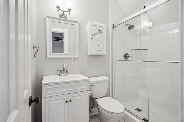 bathroom with vanity, toilet, and an enclosed shower