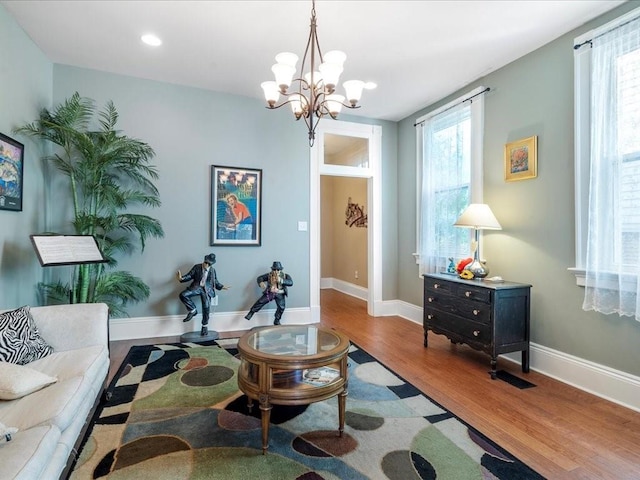 living room featuring hardwood / wood-style flooring and a notable chandelier