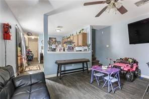 living room featuring wood-type flooring and ceiling fan