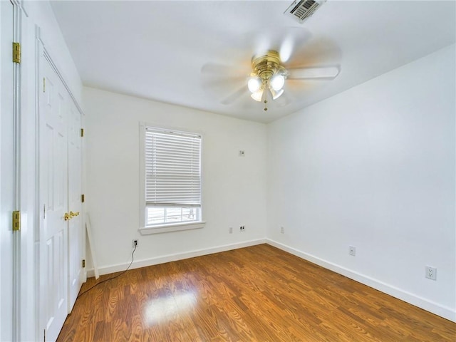 empty room with ceiling fan and hardwood / wood-style floors