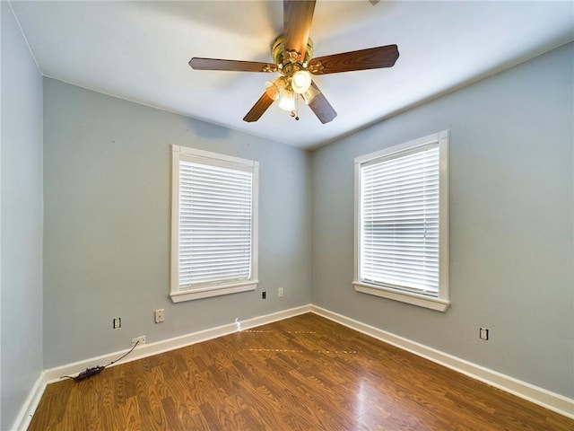 empty room with ceiling fan and dark wood-type flooring