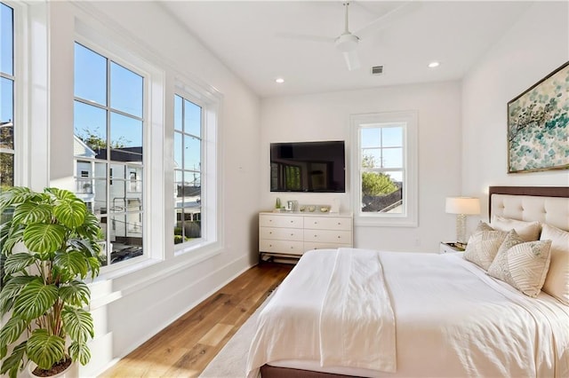 bedroom with wood-type flooring and ceiling fan