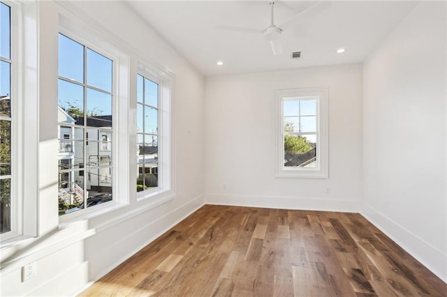 empty room with hardwood / wood-style flooring and ceiling fan