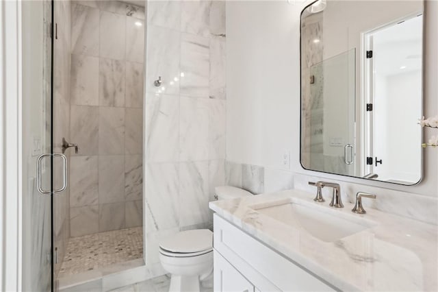 bathroom featuring vanity, toilet, and walk in shower