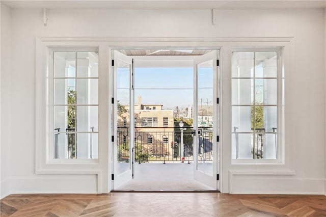 entryway featuring parquet flooring