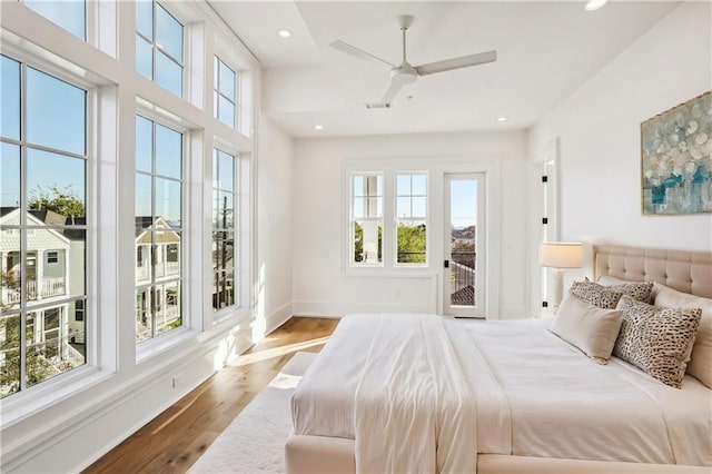 bedroom with ceiling fan, hardwood / wood-style floors, and access to outside