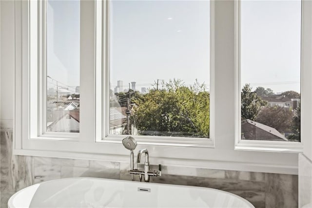 interior space featuring a sink and a soaking tub