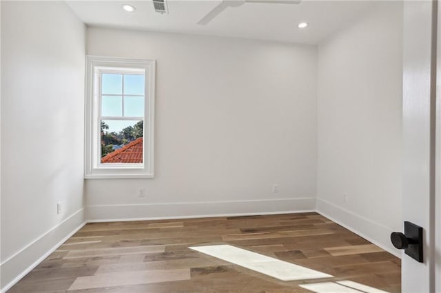 empty room with ceiling fan and hardwood / wood-style floors