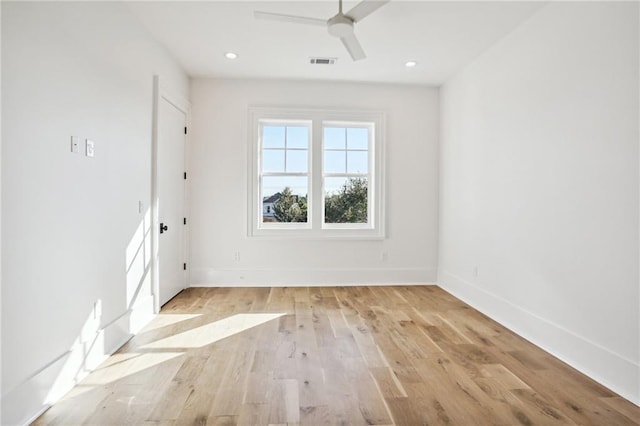 empty room featuring ceiling fan and light hardwood / wood-style flooring