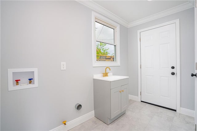 washroom featuring cabinets, sink, hookup for a gas dryer, ornamental molding, and hookup for a washing machine