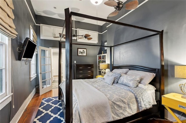 bedroom featuring dark hardwood / wood-style flooring, french doors, and ceiling fan