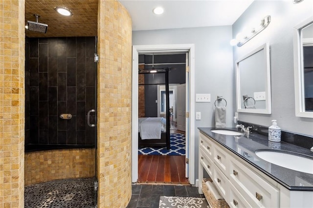 bathroom with wood-type flooring, vanity, and a shower with door