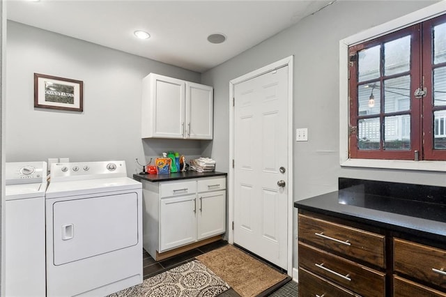 laundry room featuring cabinets, separate washer and dryer, and dark tile patterned flooring