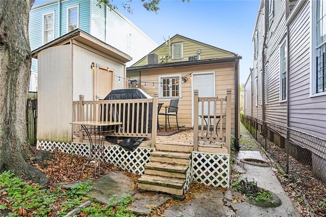 back of house featuring a wooden deck