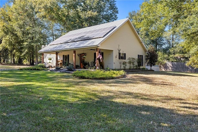 view of property exterior featuring a lawn and solar panels