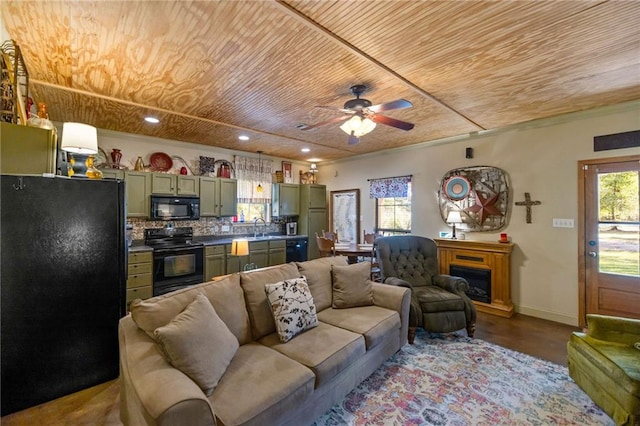 living room with hardwood / wood-style floors, wooden ceiling, ceiling fan, and sink