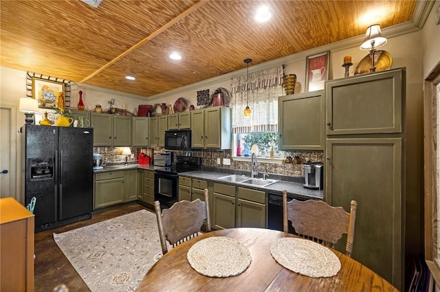 kitchen featuring black appliances, crown molding, decorative light fixtures, green cabinets, and sink