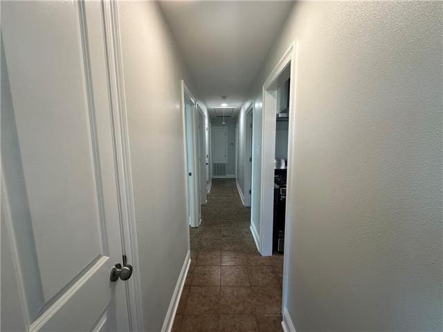 corridor with dark tile patterned floors