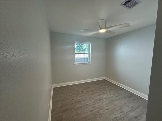 unfurnished room with hardwood / wood-style floors and ceiling fan