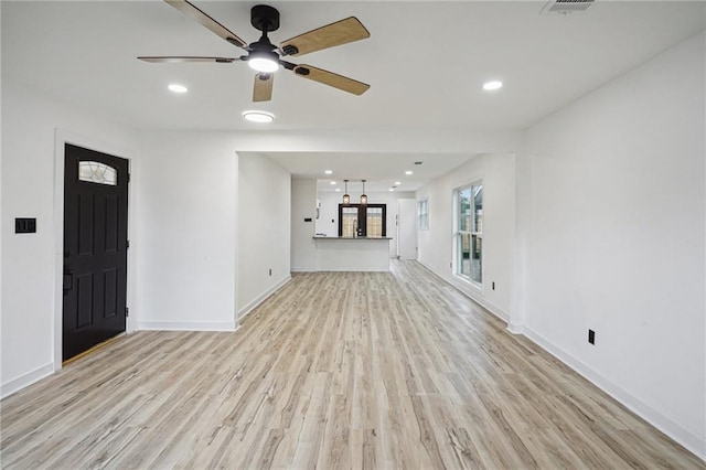 unfurnished living room with ceiling fan and light hardwood / wood-style flooring