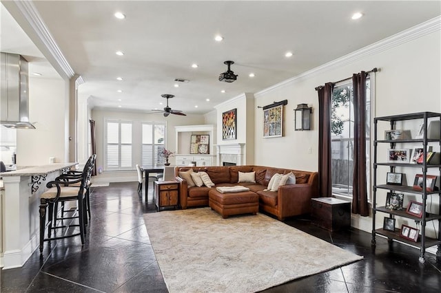 living room with ceiling fan and ornamental molding