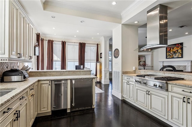 kitchen featuring light stone countertops, stainless steel gas cooktop, island exhaust hood, and cream cabinets