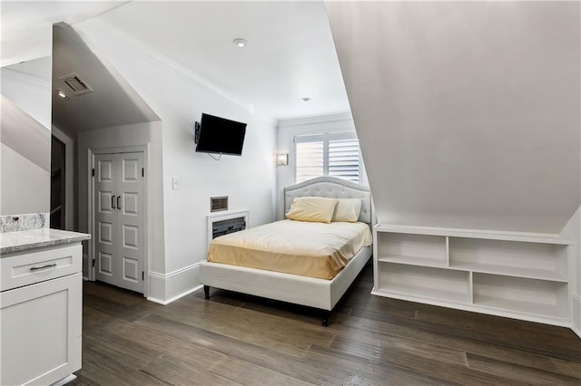 bedroom with crown molding and dark hardwood / wood-style floors