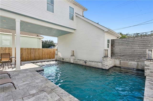 view of swimming pool with a patio and pool water feature