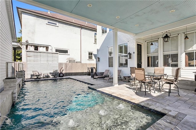 view of patio with a fenced in pool and pool water feature