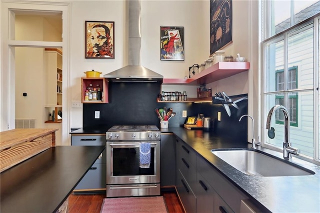 kitchen featuring sink, island range hood, dark wood-type flooring, gray cabinetry, and stainless steel range