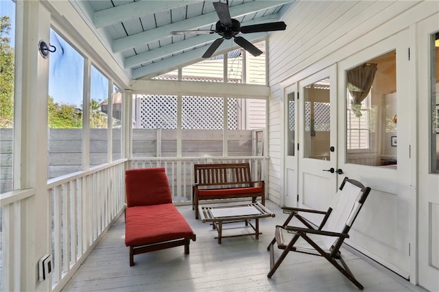 sunroom with vaulted ceiling with beams, ceiling fan, and wood ceiling