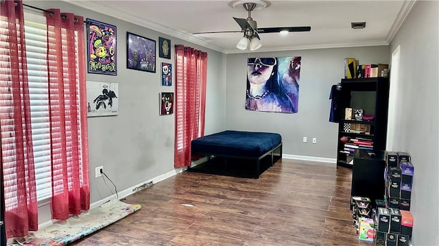 bedroom with crown molding, hardwood / wood-style flooring, and ceiling fan