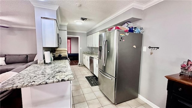 kitchen featuring light stone counters, light tile patterned flooring, ornamental molding, stainless steel appliances, and white cabinetry