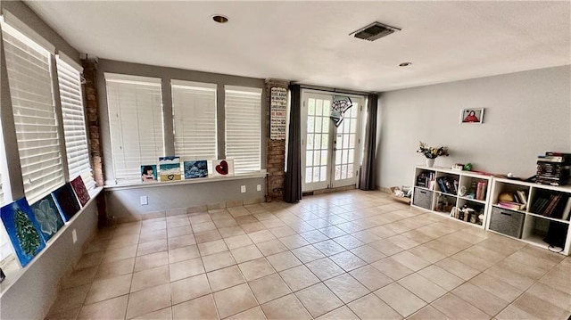 interior space with french doors and light tile patterned flooring