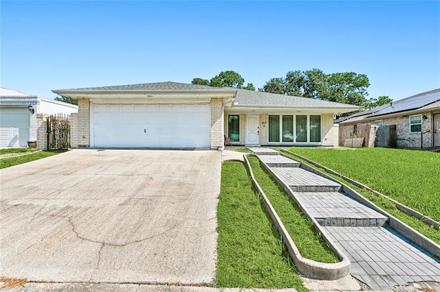 single story home with a front yard and a garage