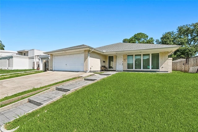 single story home featuring a garage and a front lawn