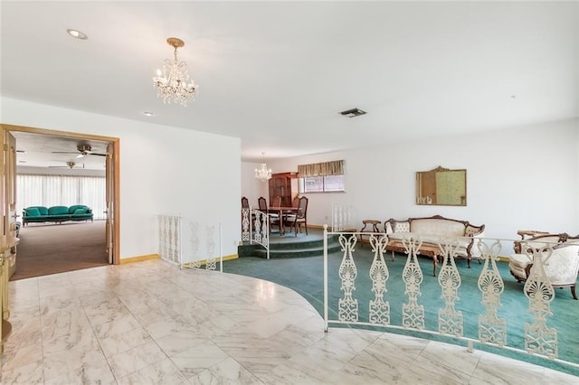 interior space with ceiling fan with notable chandelier and plenty of natural light